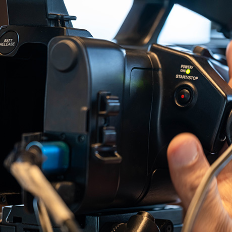 a person holding a recording camera